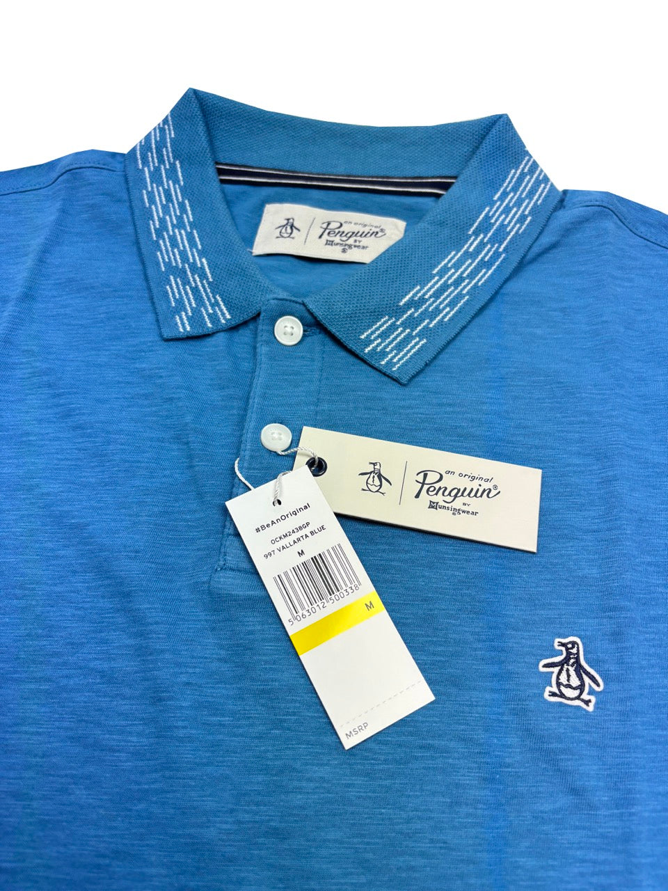 Blue polo shirt with a tag on a white background